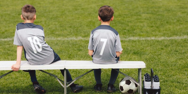 kids on the bench at soccer game